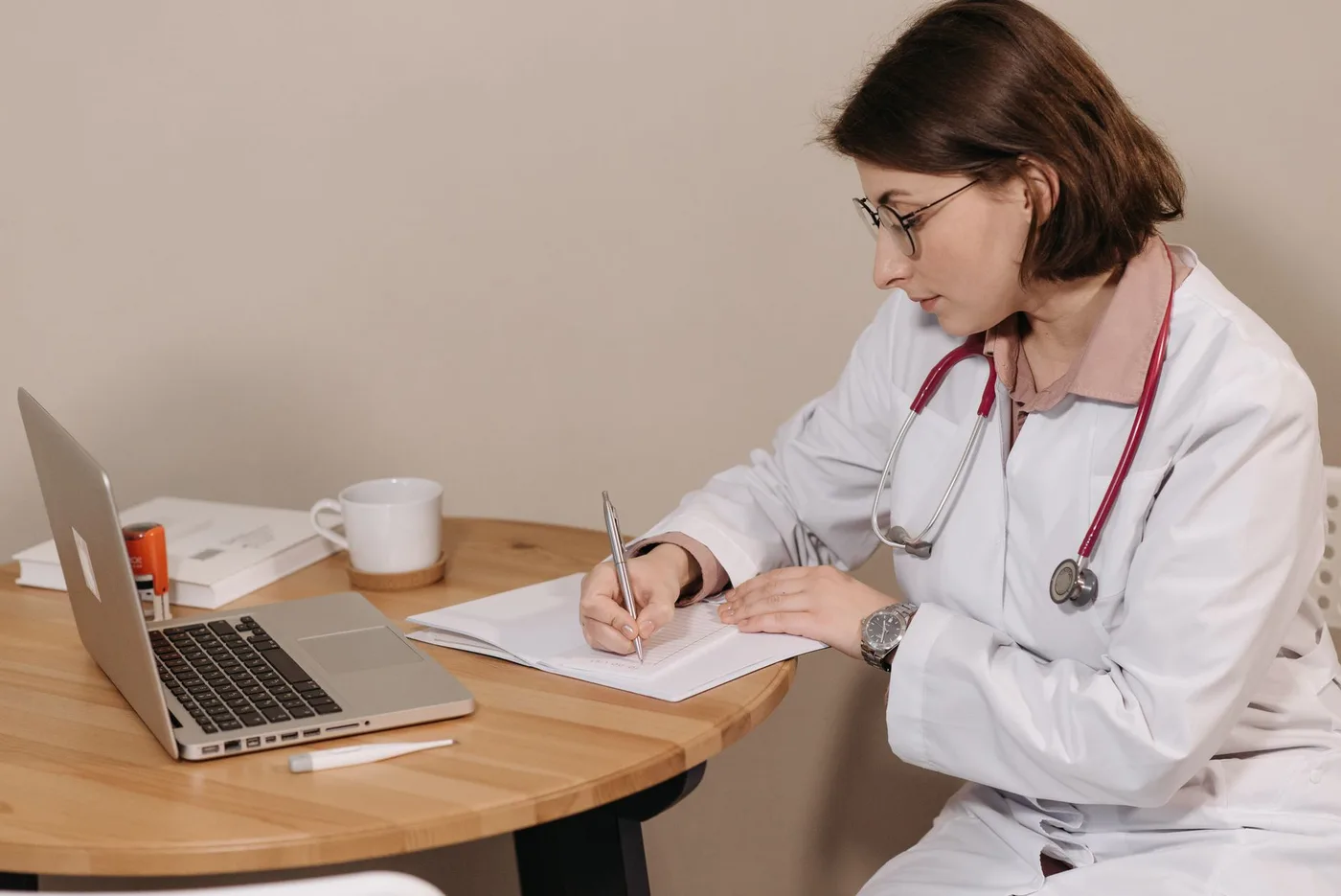Clinician studying course materials at a desk